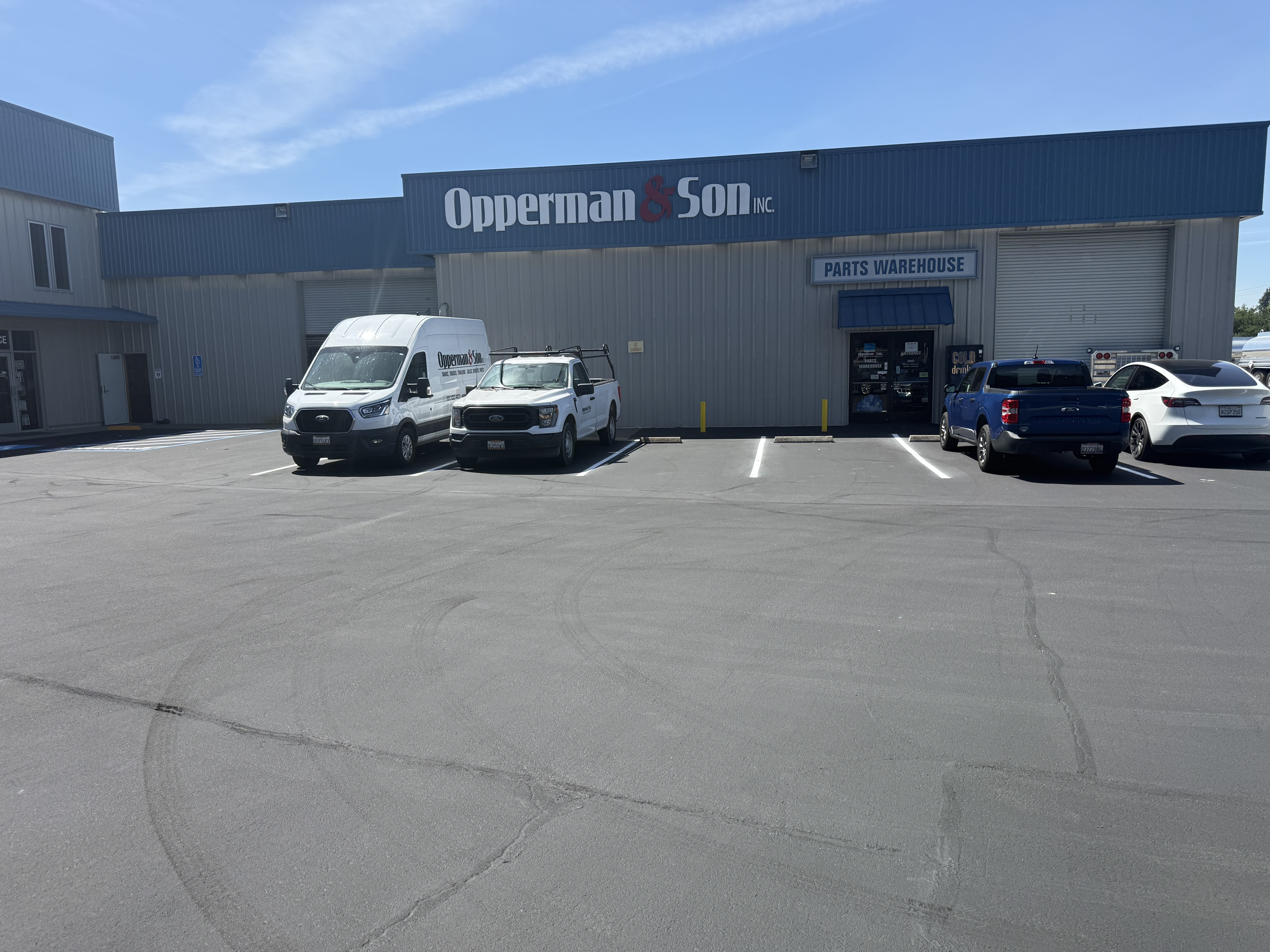 Freshly paved commercial parking lot with new striping at Opperman & Son